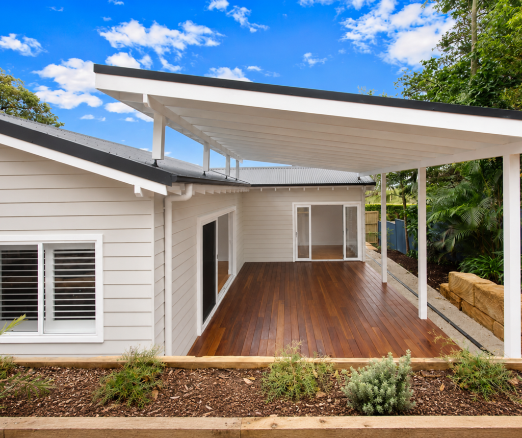 White granny flat house with new wooden deck and canopy